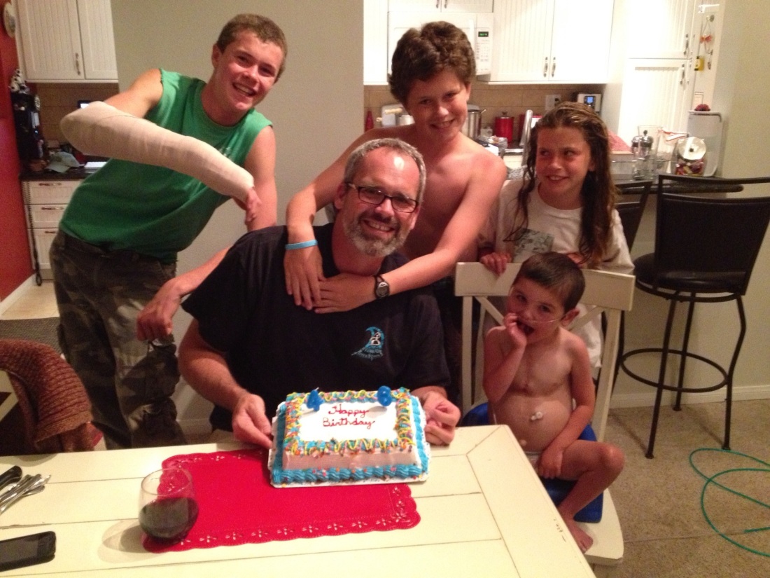 After being away with Olivia for a 2-day soccer tournament and in the ER with Wilson the evening he got back, we finally got to have a belated birthday celebration for the man of the house...complete with a Carvel ice-cream cake!  By the looks of it, Olivia wasn't too keen on the shirtless action of her brothers!